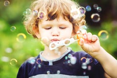 Child Blowing Soap Bubbles, Closeup Portrait. Stock Images