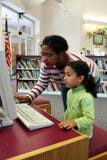 Child on Computer With Teacher