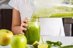 Child Cooking Spinach Apple Cucumber Smoothie. Healthy Plant Based Food Concept Royalty Free Stock Photography