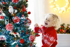 Child decorating Christmas tree. Kid on Xmas eve. royalty free stock photo Child decorating Christmas tree. Kid on Xmas eve. royalty free stock photo