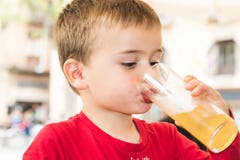 Child drinking a soda in a glass stock photos Child drinking a soda in a glass stock photos