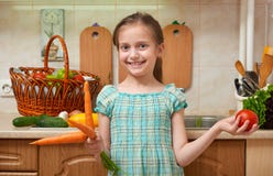 Child girl with carrot and tomatoes, vegetables and fresh fruits in kitchen interior, healthy food concept. Child girl with carrot and tomatoes, vegetables and n Royalty Free Stock Photos Child girl with carrot and tomatoes, vegetables and fresh fruits in kitchen interior, healthy food concept. Child girl with carrot and tomatoes, vegetables and n Royalty Free Stock Photos