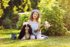 Child girl playing with her spaniel dog in summer garden Stock Photos Child girl playing with her spaniel dog in summer garden Stock Photos