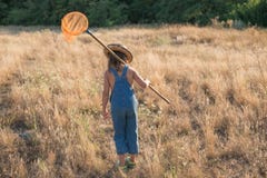 Child with a insect net catches butterfly stock photo Child with a insect net catches butterfly stock photo