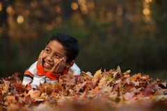 Child Laying on Autumn Leafs