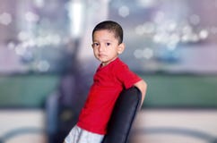 Child On Chair Looking At Camera Royalty Free Stock Photo