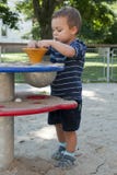 Child at playground. Child playing with sand at playground on a play table equipment stock photos Child at playground. Child playing with sand at playground on a play table equipment stock photos