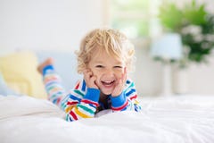 Child playing in bed. Kids room. Baby boy at home royalty free stock photos Child playing in bed. Kids room. Baby boy at home royalty free stock photos