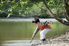 Child Playing By The Lake Stock Photography