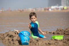 Child playing in the sand at the beach