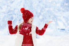 Child playing in snow on Christmas. Kids in winter royalty free stock photography Child playing in snow on Christmas. Kids in winter royalty free stock photography