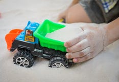 Child playing with toy car in a sand. Royalty Free Stock Image Child playing with toy car in a sand. Royalty Free Stock Image
