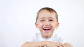 A child of preschool age experiences emotions: happiness, joy, laughter, delight. A little boy on a white background