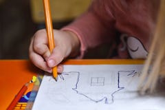 Child Preschooler Learns To Draw And Write In Notebooks At Home In The Evening Under The Light From A Desk Lamp. Stock Photography Child Preschooler Learns To Draw And Write In Notebooks At Home In The Evening Under The Light From A Desk Lamp. Stock Photography