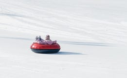 Child riding on the tubing inflatable sledges royalty free stock photo Child riding on the tubing inflatable sledges royalty free stock photo
