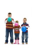 Children blowing up toy balloons