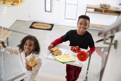 Children Bringing Parents Breakfast In Bed On Tray To Celebrate Birthday Mothers Day Fathers Day royalty free stock images Children Bringing Parents Breakfast In Bed On Tray To Celebrate Birthday Mothers Day Fathers Day royalty free stock images