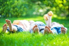 Children feet in green grass