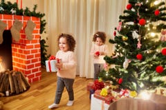 Children with gifts at Christmas, New Year's in the room with th royalty free stock photo Children with gifts at Christmas, New Year's in the room with th royalty free stock photo