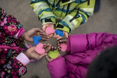 Children holding hearts in hands stock photos Children holding hearts in hands stock photos
