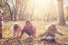 Children Playing with fallen leaves. stock photo Children Playing with fallen leaves. stock photo