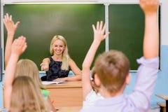 Children raising hands knowing the answer to the question royalty free stock photo Children raising hands knowing the answer to the question royalty free stock photo