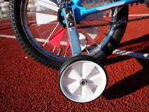 Children`s Bicycle with three wheels, small wheels can be removed stock image Children`s Bicycle with three wheels, small wheels can be removed stock image