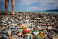 Children`s entertainment on a pebble beach-paint stones. stock image Children`s entertainment on a pebble beach-paint stones. stock image