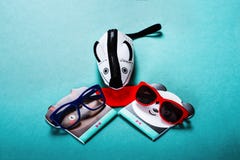Children`s sunglasses and a cover in the form of a mouse on a blue background stock photos Children`s sunglasses and a cover in the form of a mouse on a blue background stock photos