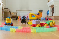 Children's toys on the floor. Close-up. Children's excavator, train and car. The children left behind a mess of toys in the livi stock photography Children's toys on the floor. Close-up. Children's excavator, train and car. The children left behind a mess of toys in the livi stock photography