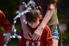 Children from the same family standing at the fountain in the city Park. stock image Children from the same family standing at the fountain in the city Park. stock image