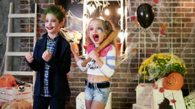Children screaming, harley quinn and joker costumes, crazy characters, kids having fun at halloween stock footage Children screaming, harley quinn and joker costumes, crazy characters, kids having fun at halloween stock footage