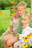 Children sitting on bench in garden stock photos Children sitting on bench in garden stock photos