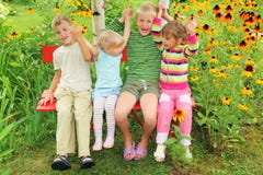Children sitting on bench in garden royalty free stock image Children sitting on bench in garden royalty free stock image