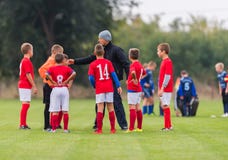 Children soccer players playing football and coaches training th royalty free stock image Children soccer players playing football and coaches training th royalty free stock image