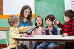 Children And Teacher Playing With Musical royalty free stock images Children And Teacher Playing With Musical royalty free stock images