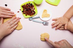 Children with their mother learn to cook cookies with berries, close-up royalty free stock images Children with their mother learn to cook cookies with berries, close-up royalty free stock images