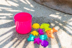 Childrens beach bright pink toys on a sandy concrete background. stock image Childrens beach bright pink toys on a sandy concrete background. stock image