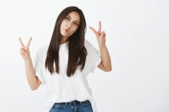 Chill and be positive. Portrait of joyful happy girl in casual outfit, raising hands in victory or peace gesture stock image Chill and be positive. Portrait of joyful happy girl in casual outfit, raising hands in victory or peace gesture stock image
