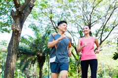 Chinese man and woman jogging in city park royalty free stock images Chinese man and woman jogging in city park royalty free stock images