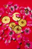 Chinese New Year - Emperor's Coins Ornaments II. Golden coins ornaments with plastic cherry blossoms on red surface for CNY celebration in portrait orientation vector illustration Chinese New Year - Emperor's Coins Ornaments II. Golden coins ornaments with plastic cherry blossoms on red surface for CNY celebration in portrait orientation vector illustration