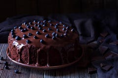 Chocolate cake decorated with blackberries on vintage wooden table background Stock Image Chocolate cake decorated with blackberries on vintage wooden table background Stock Image