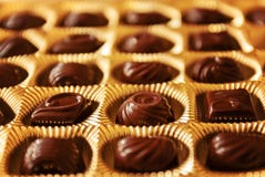 Chocolate candies of different shapes in a gold box, a perspecti royalty free stock photography Chocolate candies of different shapes in a gold box, a perspecti royalty free stock photography