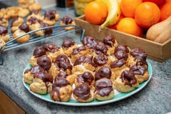 Chocolate covered vanilla cream pastry puffs close up. The chocolate covered vanilla cream pastry puffs closeup Stock Photos Chocolate covered vanilla cream pastry puffs close up. The chocolate covered vanilla cream pastry puffs closeup Stock Photos