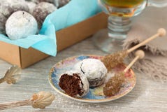 Chocolate homemade cookies in powdered sugar with tea and caramel sugar stock images Chocolate homemade cookies in powdered sugar with tea and caramel sugar stock images