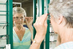 Choosing glasses at the optician Royalty Free Stock Image Choosing glasses at the optician Royalty Free Stock Image