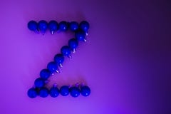Christmas alphabet of blue neon Christmas balls on a gradient lilac background royalty free stock images Christmas alphabet of blue neon Christmas balls on a gradient lilac background royalty free stock images