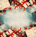 Christmas Background With Gift Boxes, Red Festive Holiday Decorations And Paper Snowflakes Stock Photos