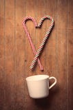 Christmas candy cane and white cup of coffee Royalty Free Stock Photography Christmas candy cane and white cup of coffee Royalty Free Stock Photography