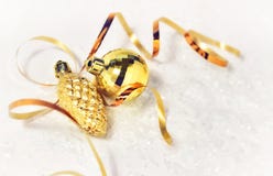 Christmas card. golden christmas decorations ball, pinecone, golden ribbon on a white background with snow and soft lights stock photo Christmas card. golden christmas decorations ball, pinecone, golden ribbon on a white background with snow and soft lights stock photo